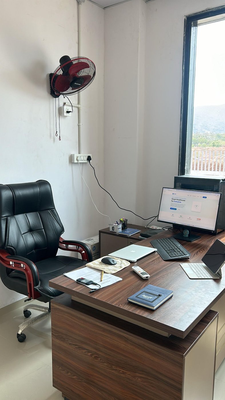 AIYOU Solutions office at AMTZ Visakhapatnam — executive desk with monitor showing the AIYOU website